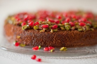 Pistachio and lime syrup cake with pomegranate seeds.