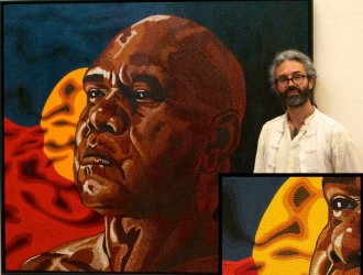 Sunshine Coast artist Jandamarra Cadd in front of his Archibald finalist painting of Archie Roach, Proud, acrylic on canvas..