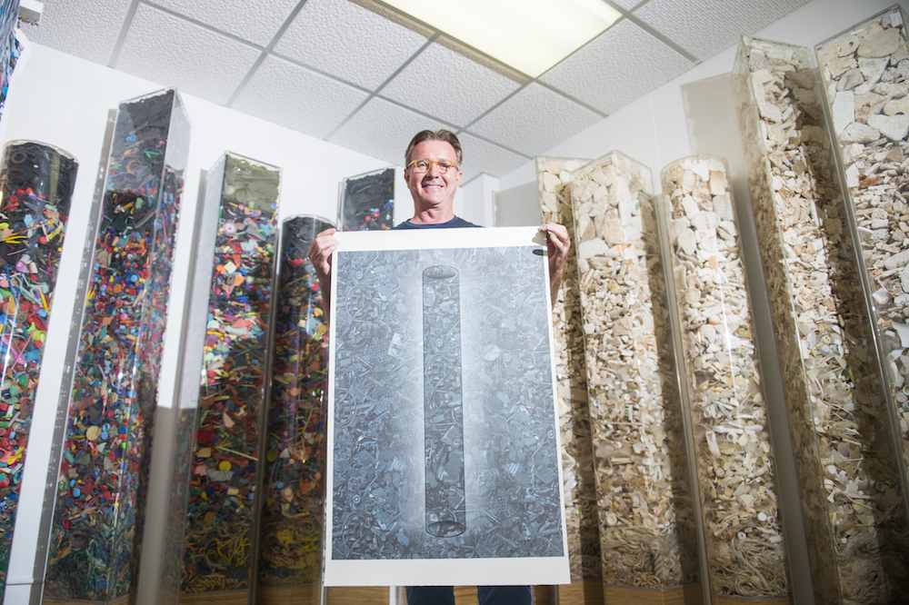 Artist John Dahlsen surrounded by his environmental art works.