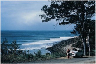 From  The Beach: An Australian Passion- pages 74- 75: photo taken by John Witzig: Bob McTavish Standing Next to a 1948 Holden Complete with Surfboard on the Roof Racks, National Park, Noosa Heads, Queensland 1966.