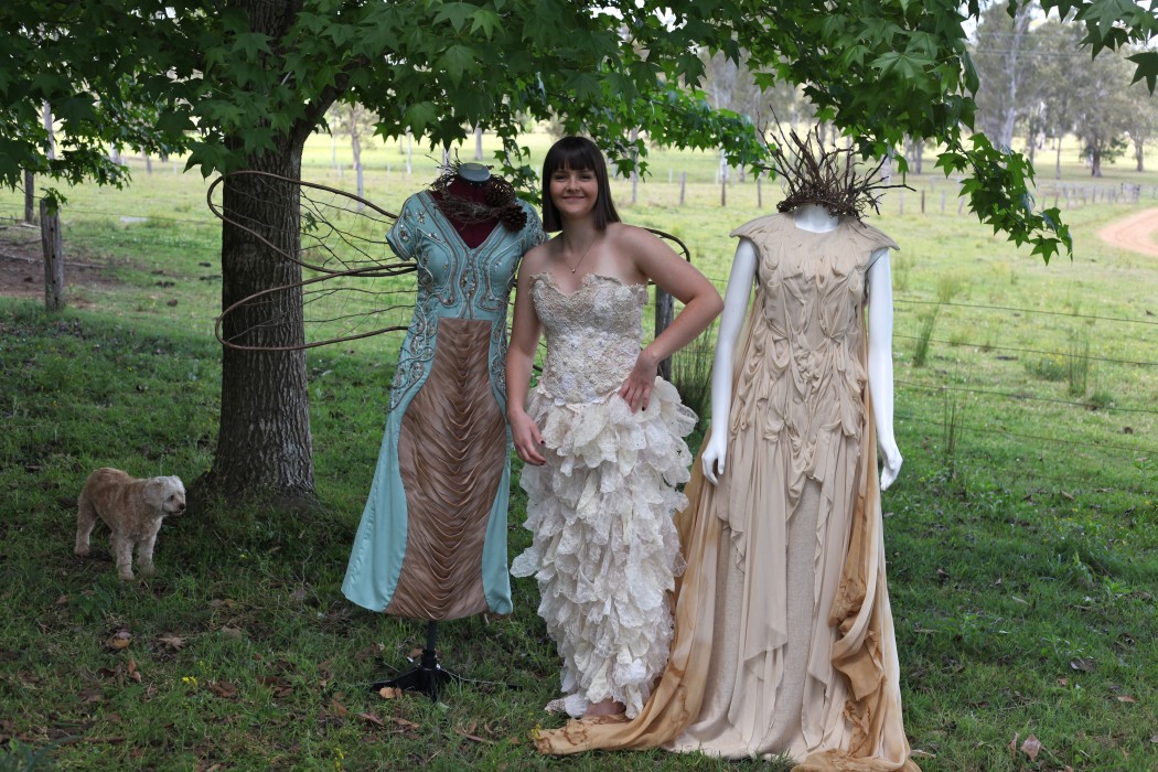 Annalise Burton on her family's Mongogarie property near Casino, with two of her designs from her TAFE diploma.