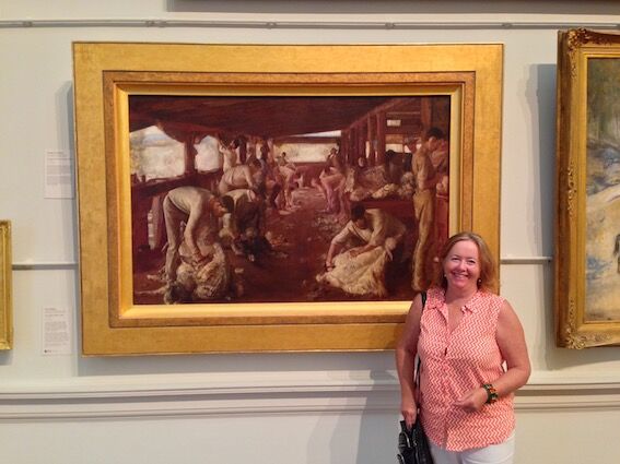 Christine Porter in front of The Golden Fleece by Tom Roberts at the Art Gallery of New South Wales.